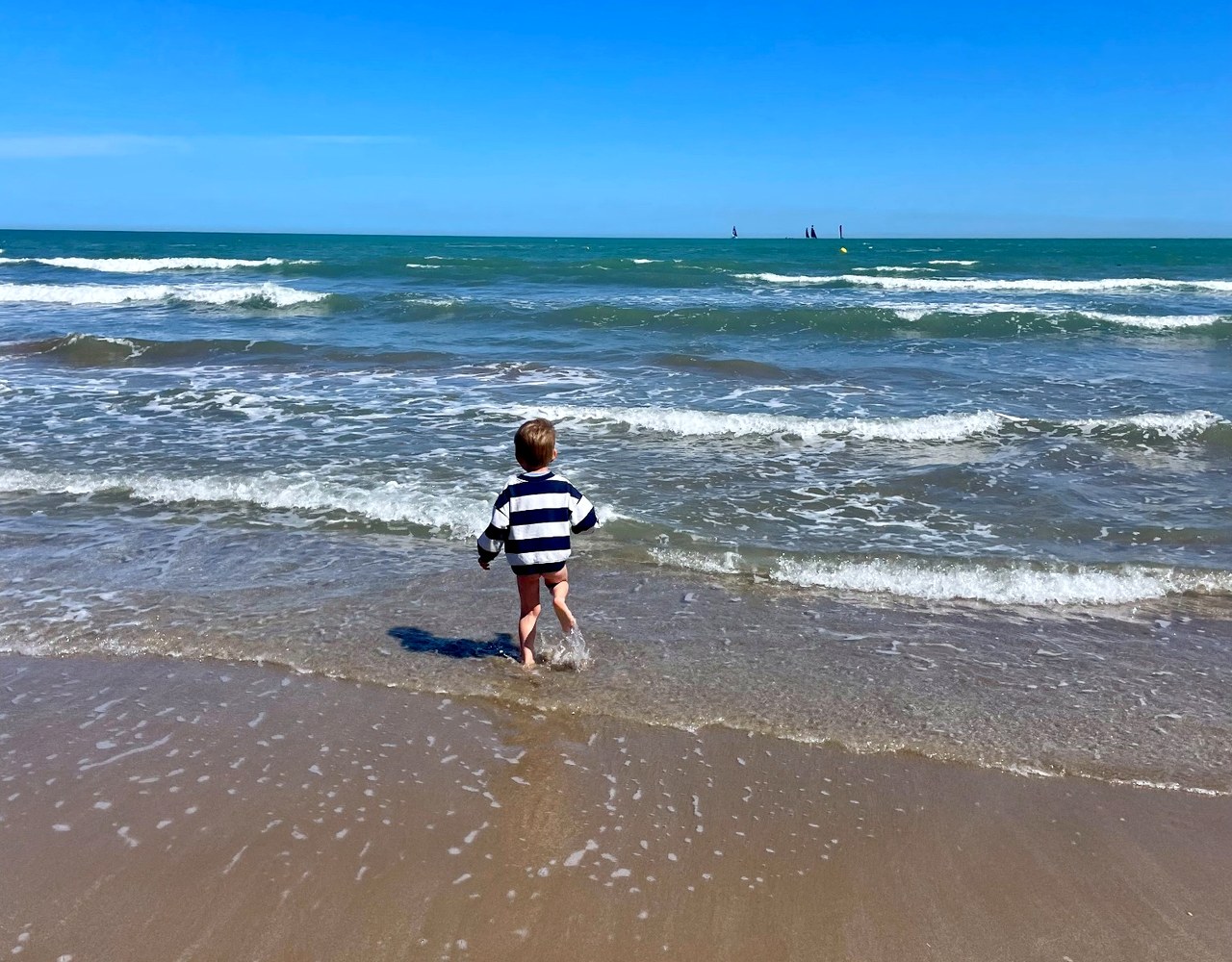 Child standing in the sea in Valencia